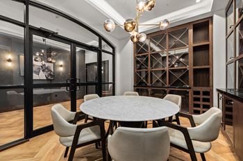 A modern dining room with a round table and chairs.